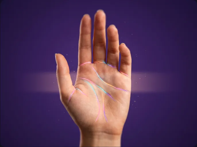 An open palm with the heart, life and fate lines traced in colour